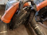 an orange and black blower sitting on top of a floor next to a pile of dirt