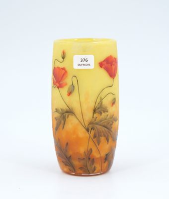 a yellow vase with red flowers painted on it