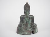 an image of a statue of a buddha sitting on a rock