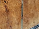 a close up of a piece of wood with a knife stuck in it