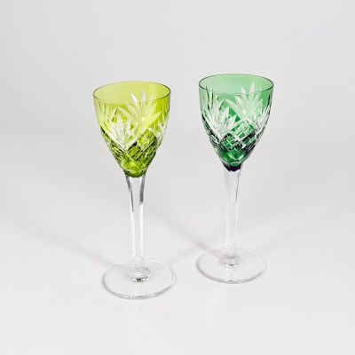 pair of green and yellow glass goblets on a white background
