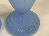 two vases that are sitting on a table