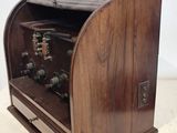 an old fashioned radio with a wooden case on top of it