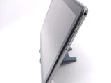 a tablet computer sitting on a stand on a white surface