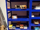 une étagère bleue sur laquelle sont posées de nombreuses boîtes, dans une pièce