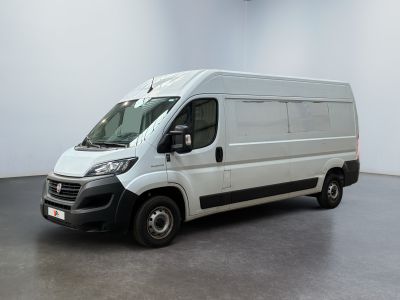 a picture of a white van parked in a large room