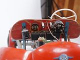 a red toy car with a snowboard on top of it