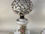 a white table with a vase and a plate on it