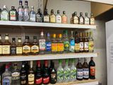 many bottles of alcohol on the shelves in the kitchen