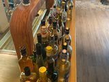 many bottles of alcohol lined up on the bar