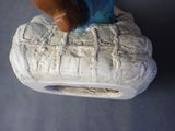 a figurine of a person riding a horse on top of a log