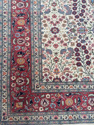 un gros plan d'un tapis posé sur une surface blanche, avec une bordure rouge
