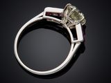 a close up of a ring with a yellow diamond and a purple sapphire