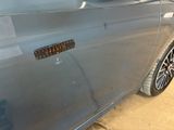 a close up of a car door with a sticker on it