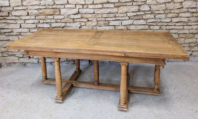 an image of a wooden table sitting in front of a stone wall