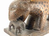 a statue of a leopard that is sitting on top of a table