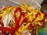 a pile of colorful ribbons on the floor next to a toilet