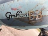 a close up of a blue motorcycle with a grill on it