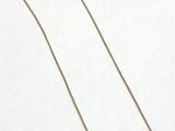 a necklace with a gold chain on a white background