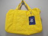 a yellow tote bag with a blue tag on it