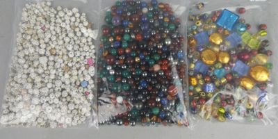 three bags of beads and beads on the table