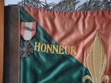 a picture of a flag with a coat of arms and a fleur de lis on it