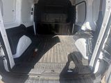 a man standing in the back of a van with the door open