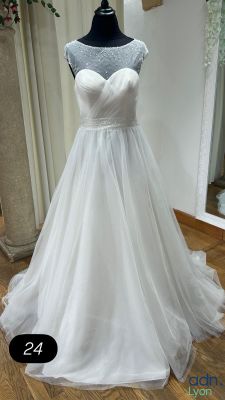 a wedding dress on a mannequin display in a store