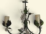wrought iron wall sconce with flowers and leaves on it