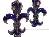 pair of blue and gold fleur de lis vases on a white surface