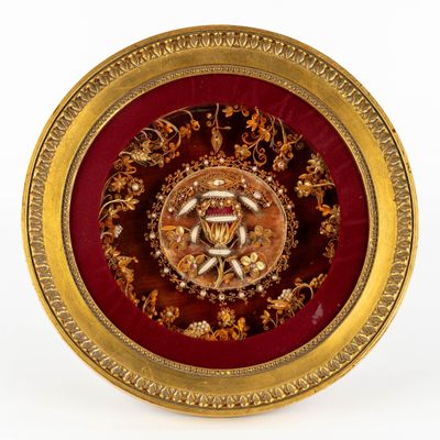 a gold and red plate with a gold and red design on it