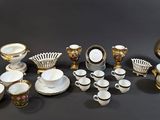 many different types of coffee cups and saucers on the table