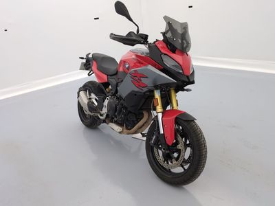 a red and black motorcycle parked in a white room