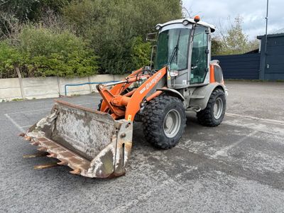 a tractor that is parked in a parking lot