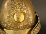 a gold helmet with a shield on top of it