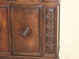 a wooden cabinet with a door on top of it