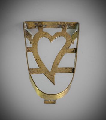 a close up of a metal object with a heart on it