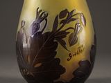 a vase with a design on it sitting on a table