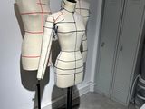 two mannequins sitting on a stand in a room