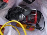 a red and black reel and a yellow hose in a white bag