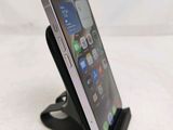 a cell phone that is on a stand on a table
