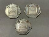 trois pièces d'argent sur lesquelles figure l'image d'un temple