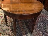 a wooden table with a wooden top on a rug