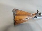 a wooden and metal object on a white surface