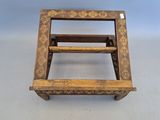 an old wooden step stool sitting on top of a white floor