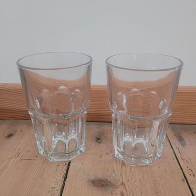 two shot glasses sitting on the floor next to each other