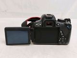 a digital camera sitting next to a monitor on a table
