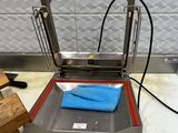 a machine that is sitting on a table with a blue towel