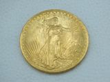 a close up of a gold coin on a white surface