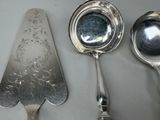 three spoons and a ladle sitting on a table